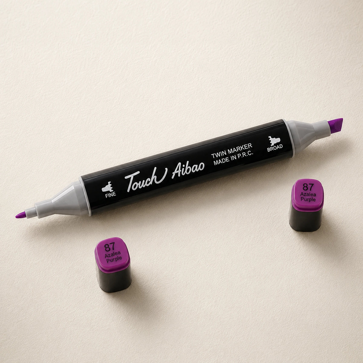 Single twin alcohol marker in Azalea Purple, caps off, showing the broad chisel nib and the fine bullet nib