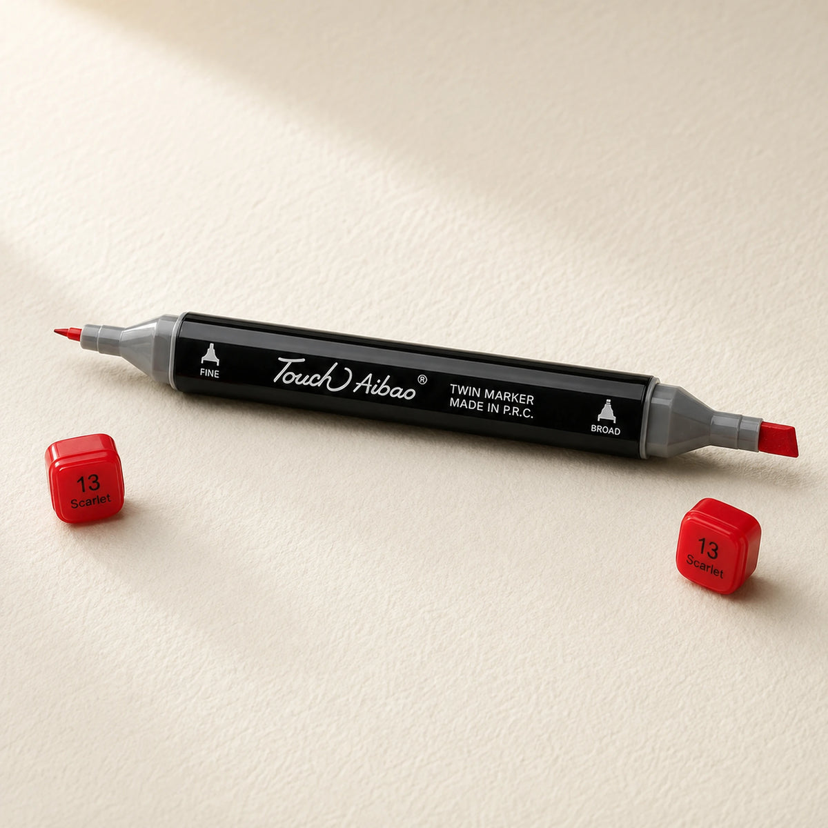 Single twin alcohol marker in Scarlet, caps off, showing the broad chisel nib and the fine bullet nib