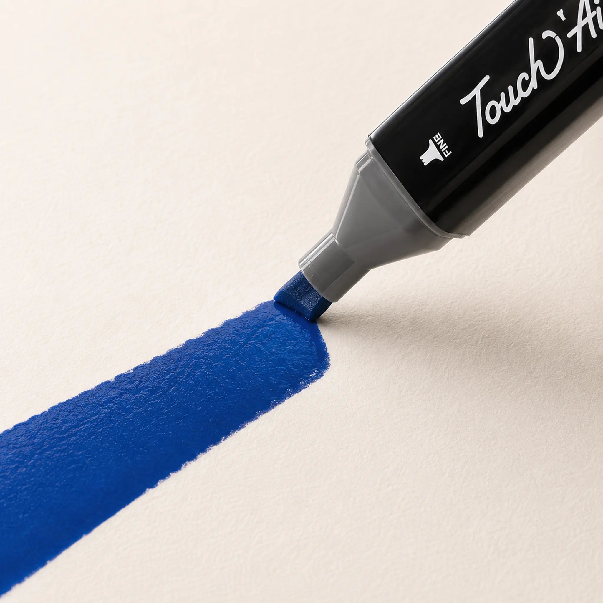 Chisel nib of a TOUCH alcohol marker laying a wide fully saturated blue stroke on marker paper