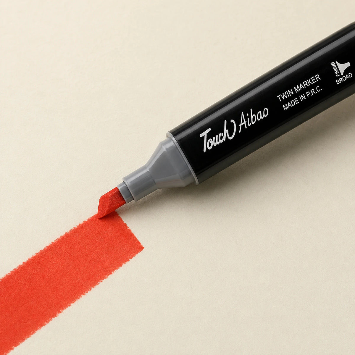 Broad chisel nib of a Touch Aibao marker laying a wide 14 Vermilion stroke across ivory art paper