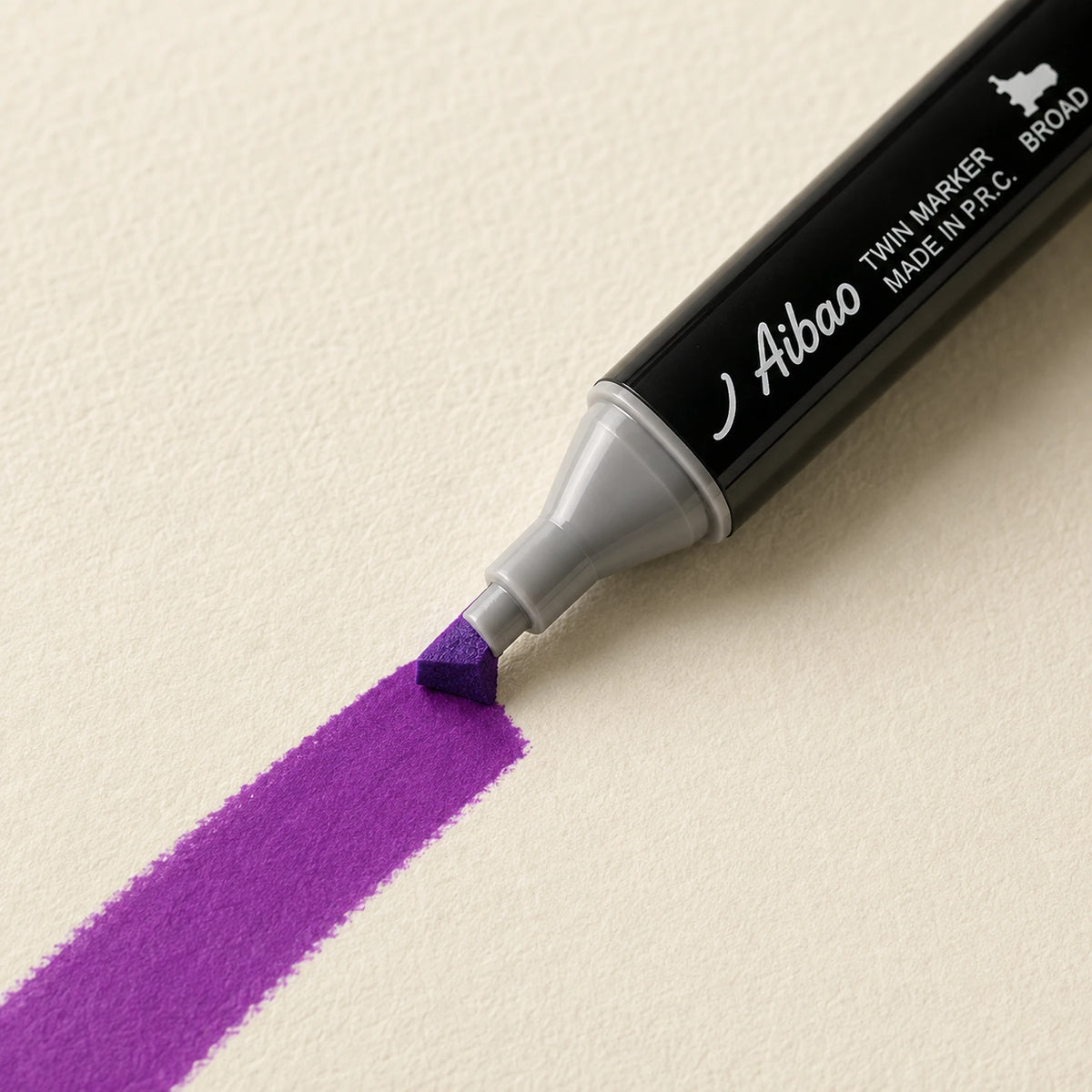 Broad chisel nib laying a wide Azalea Purple alcohol marker stroke across ivory art paper