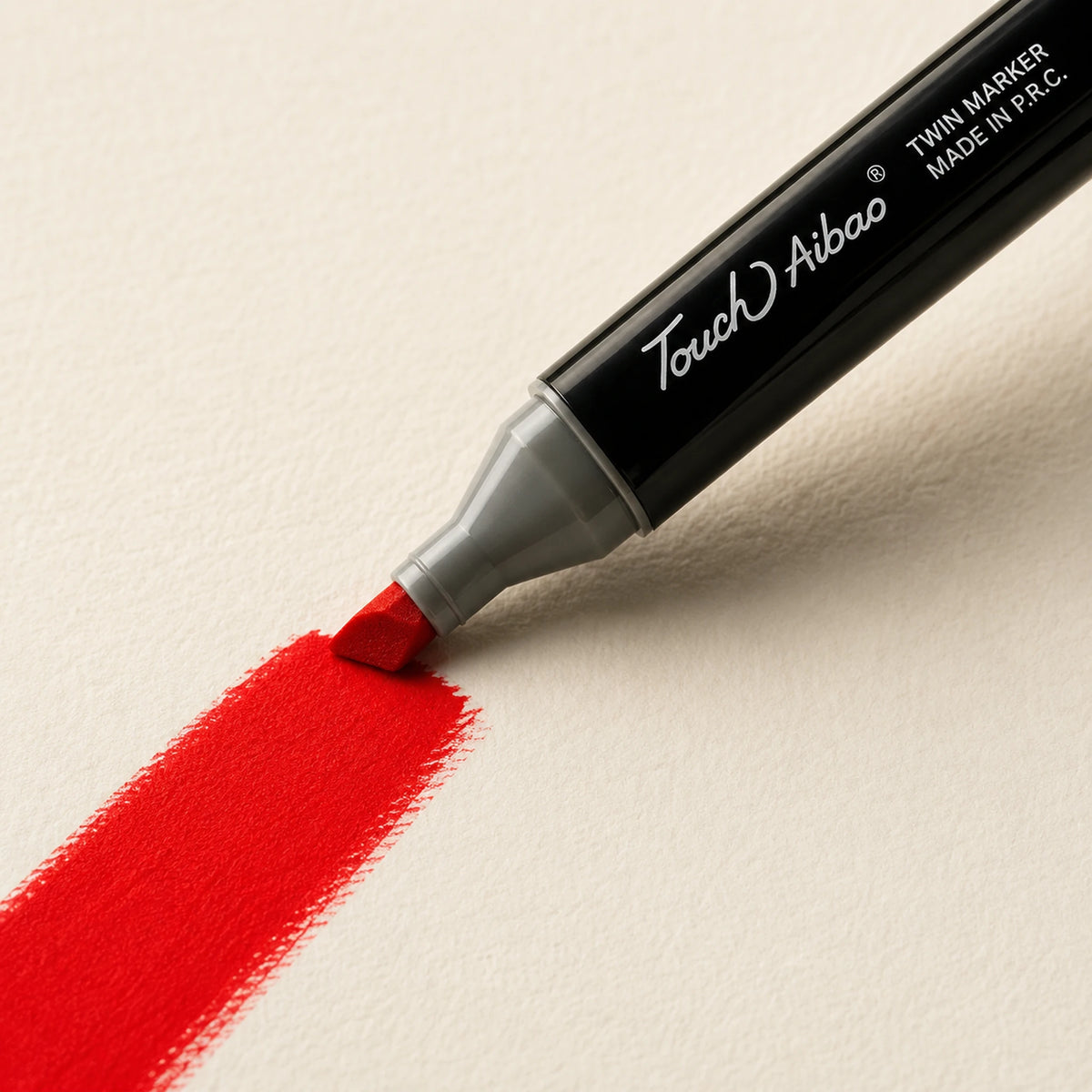 Broad chisel nib laying a wide Scarlet alcohol marker stroke across ivory art paper