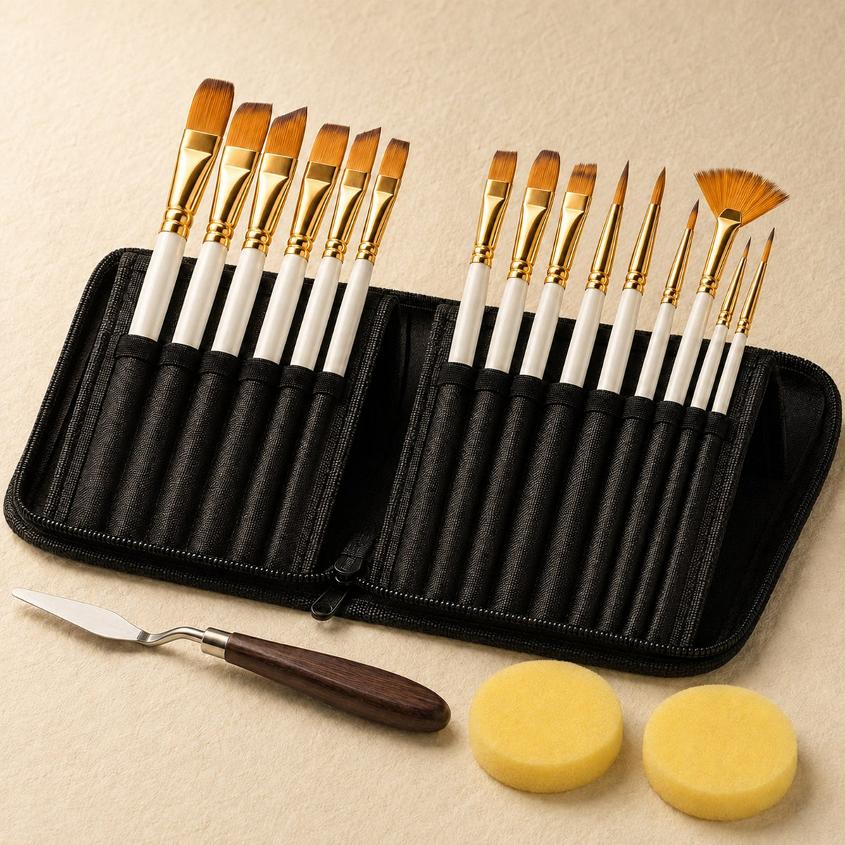 Close view of the fifteen brushes standing in the open zip case on warm ivory, showing white handles and gold ferrules, with the palette knife and two sponges in front.