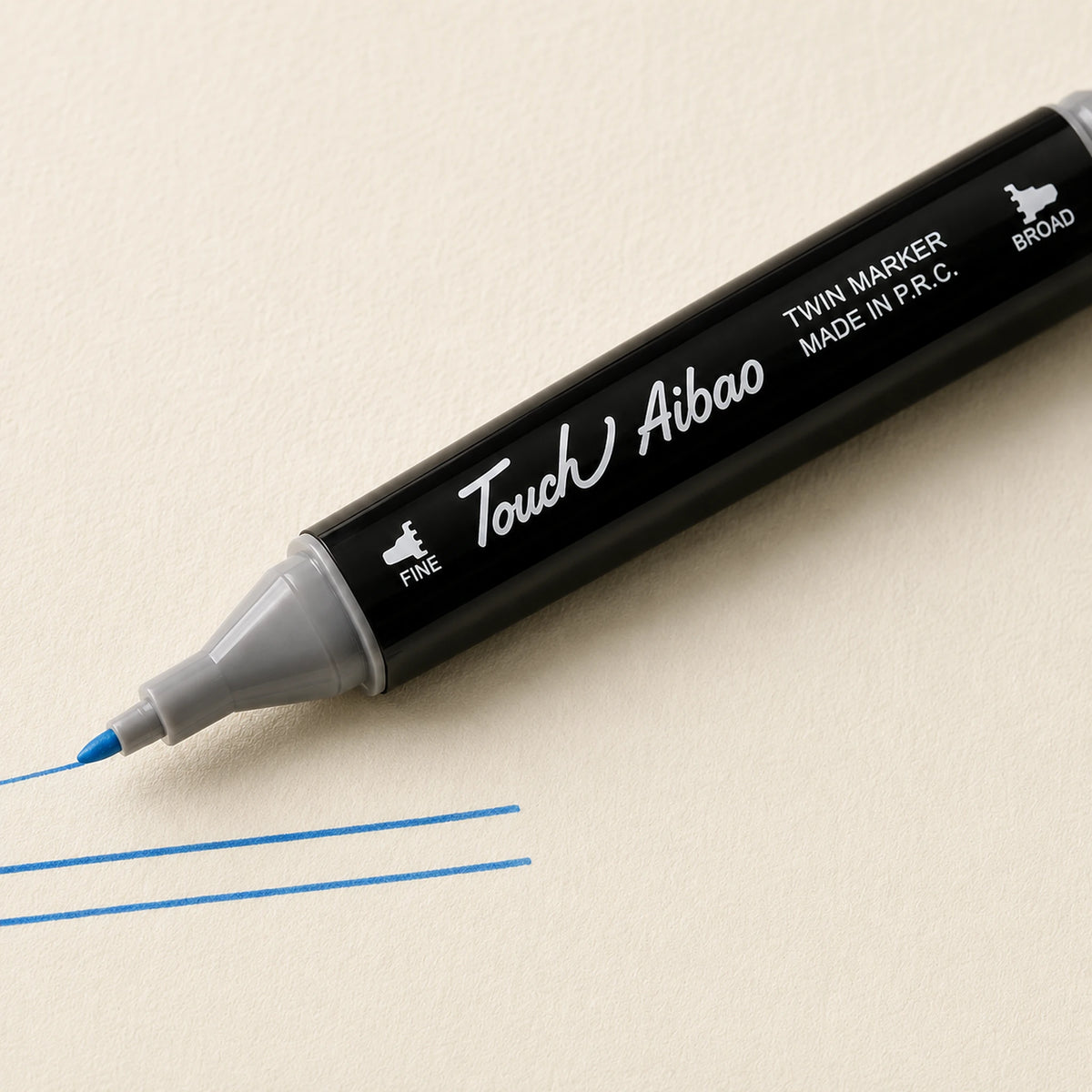 Fine bullet nib of a Touch Aibao marker drawing a crisp thin Cerulean Blue line on ivory art paper