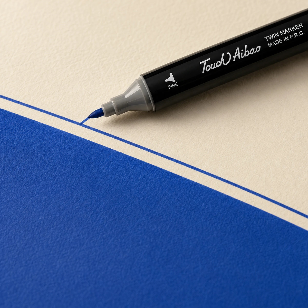 Fine bullet nib of a Touch Aibao marker drawing a crisp thin 70 Royal Blue line on ivory art paper