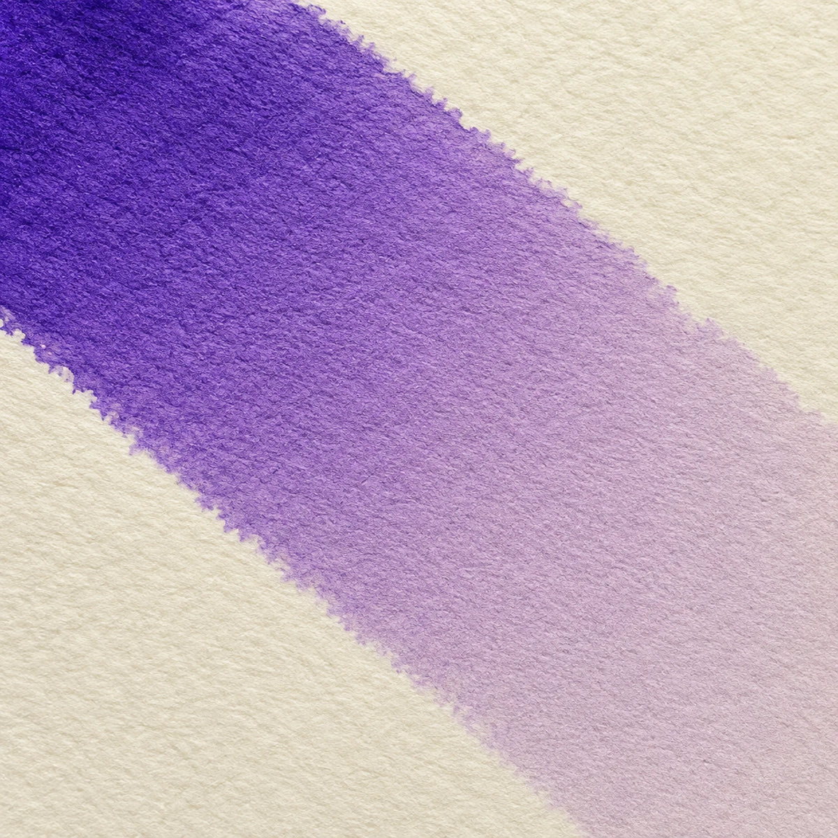 Close macro of alcohol ink blending from deep violet into pale mauve on ivory art paper