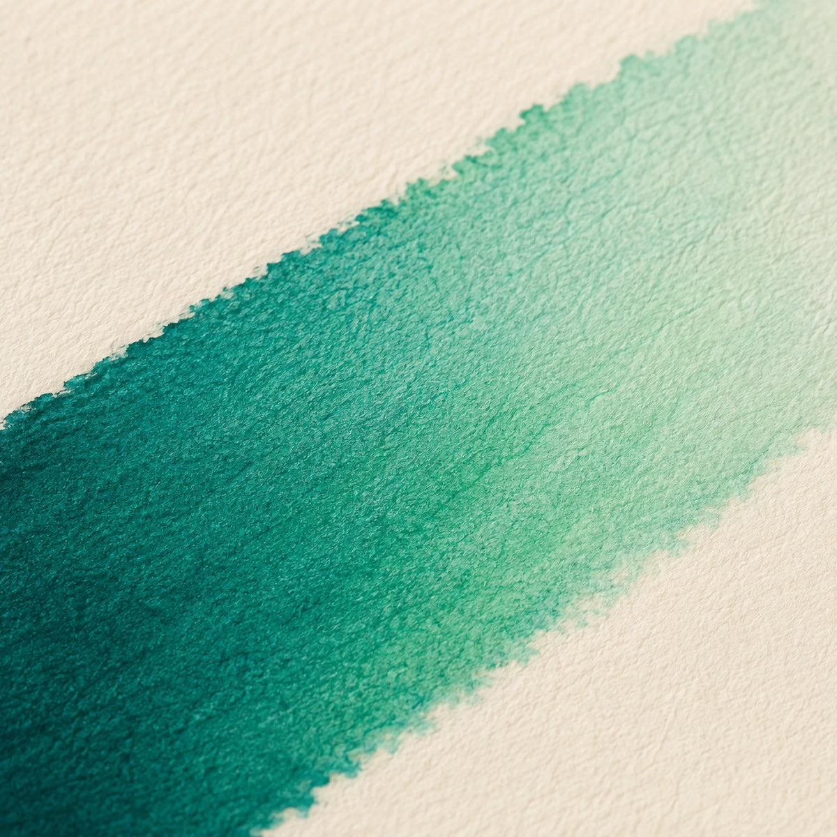 Close macro of alcohol ink blending from Peacock Green into Mint Green Light in one seamless band on ivory art paper