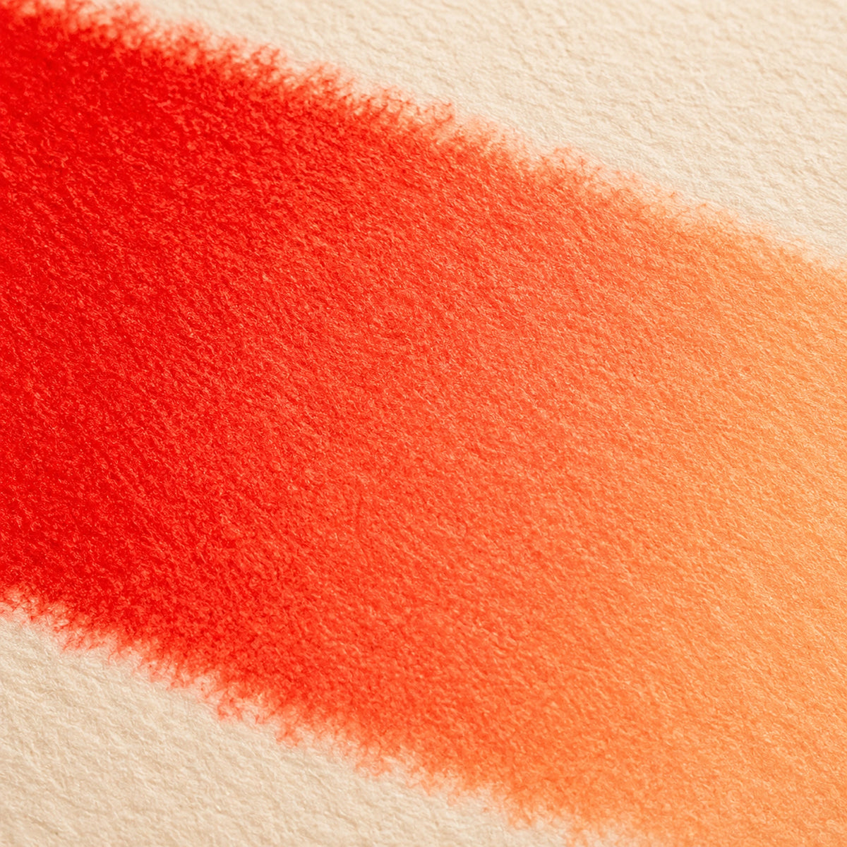 Close macro of alcohol ink blending from Scarlet into Peach in one seamless band on ivory art paper