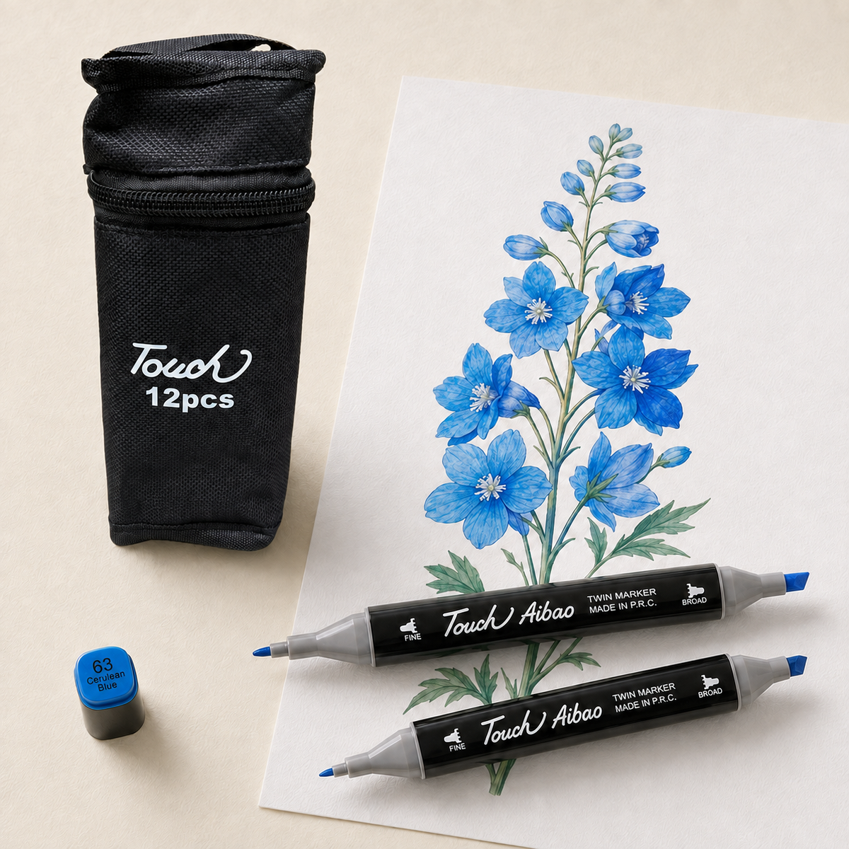Delphinium flower study in blues beside the closed TOUCH 12 alcohol marker set and two loose markers