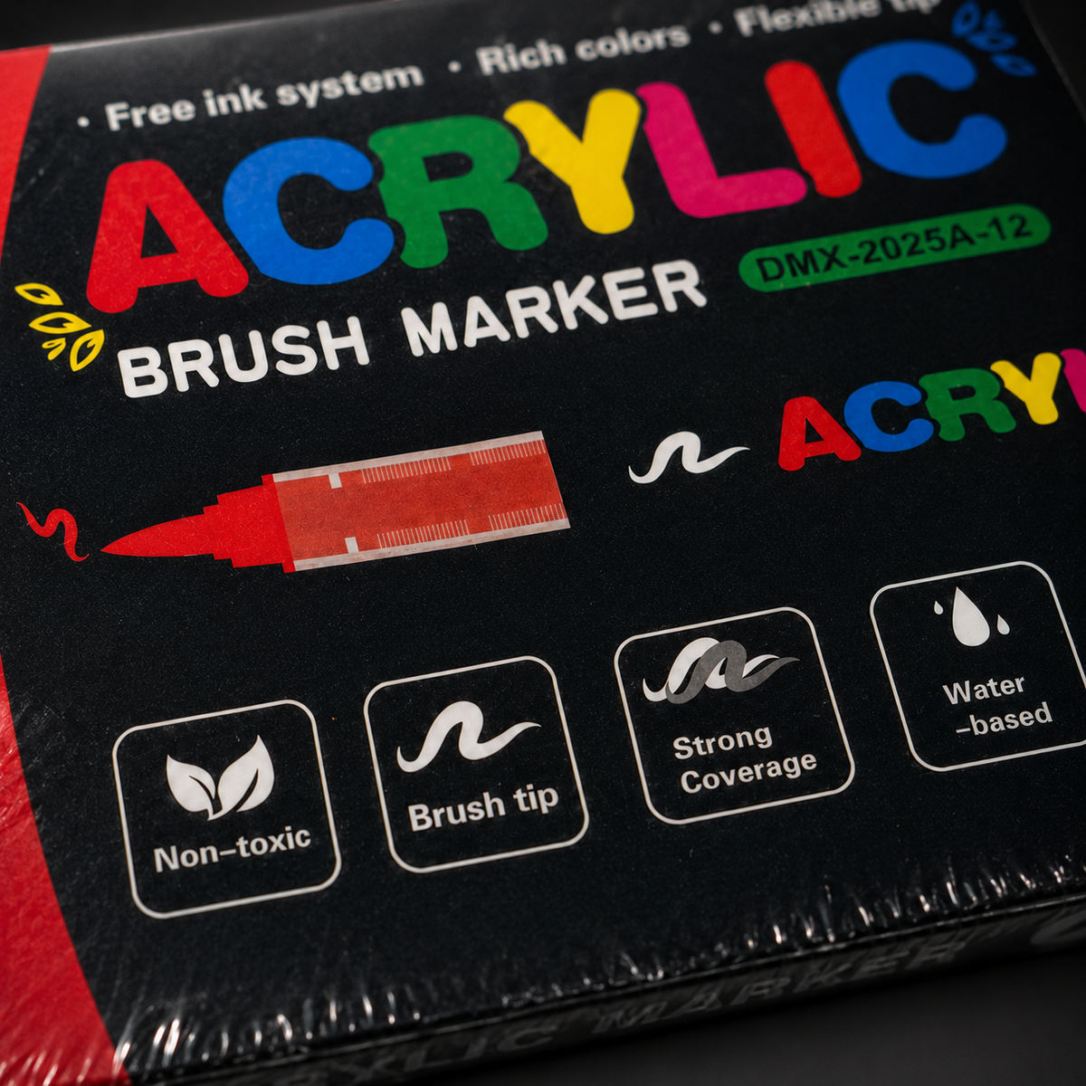 Close detail of the acrylic marker carton print showing the Non-toxic, Brush tip, Strong Coverage and Water-based feature icons