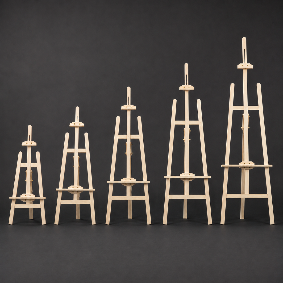 Five sizes of wooden artist easel lined up for comparison
