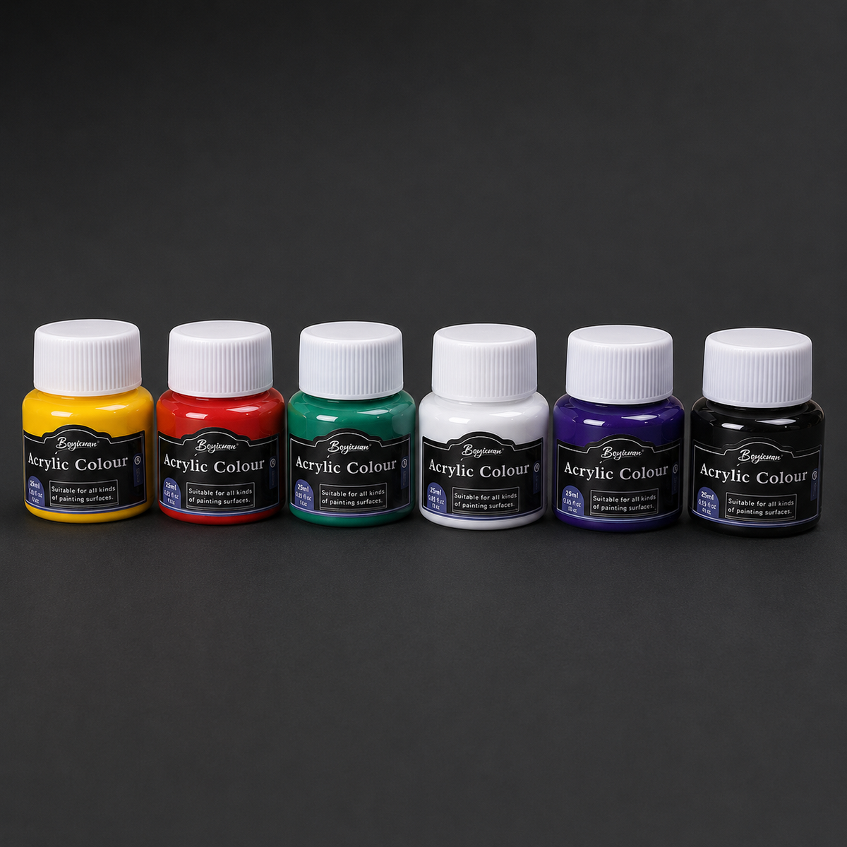Six pots of acrylic colour in a row: yellow, red, green, white, purple and black