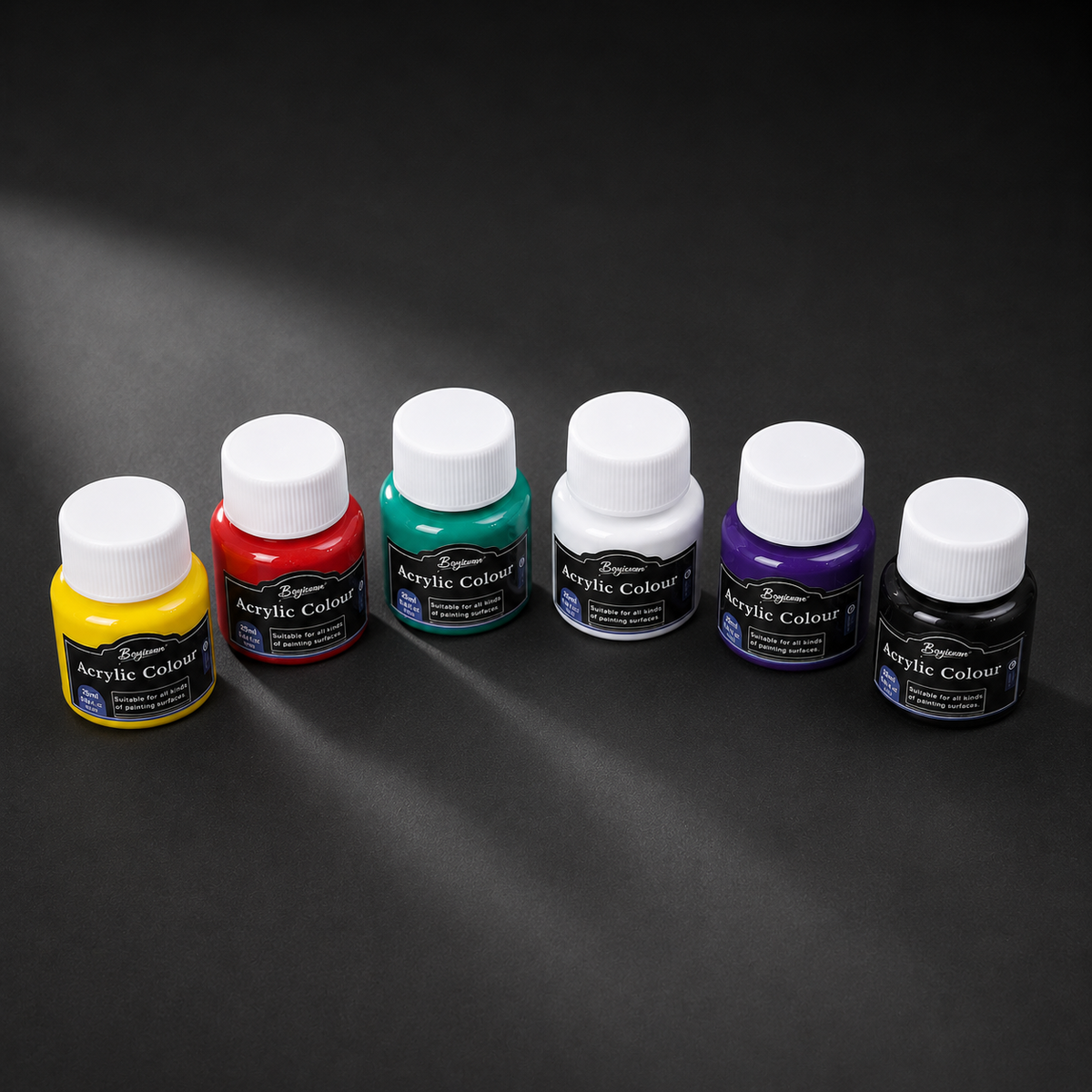 The six acrylic colour pots lined up by size